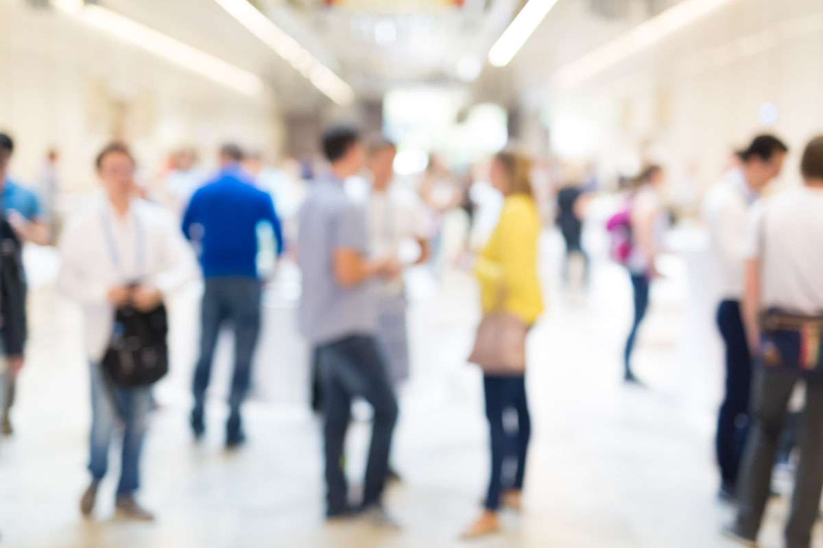 Abstract blurred people socializing during coffee break at business meeting or conference.